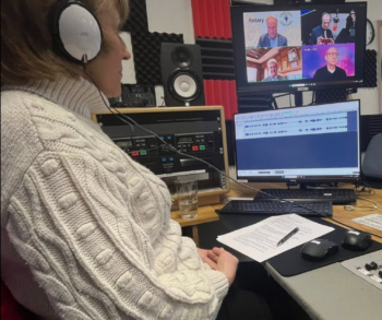 Woman in recording studio hosting the Rotary podcast