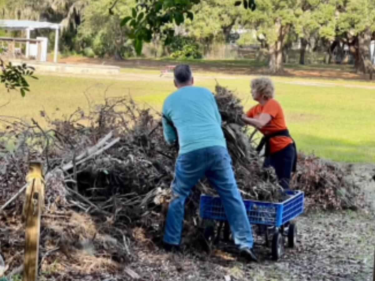 Two Global Travelers cleaning up a Rotary camp in Florida after a hurricane