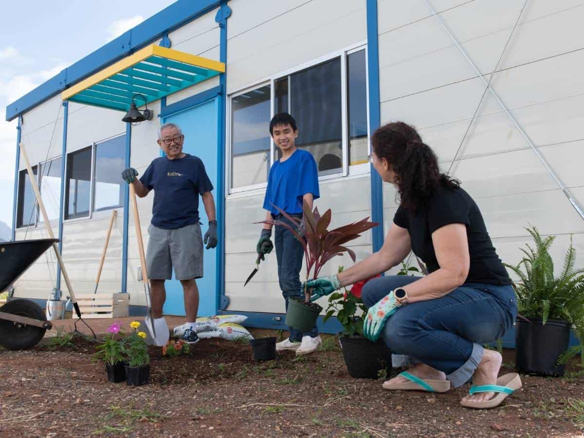 EArthDay A man, woman and child planting plants for Earth Day