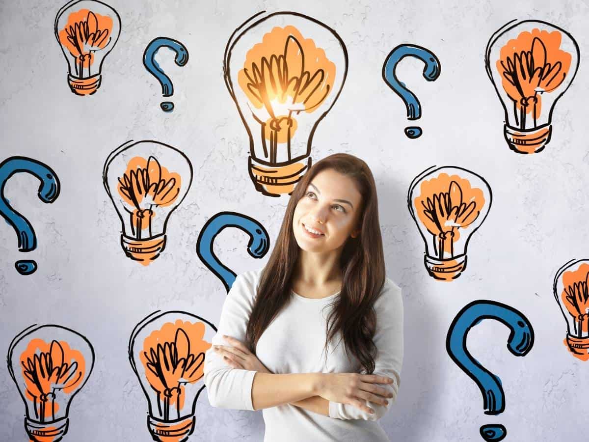 FAQ Woman surrounded by lightbulbs and question marks