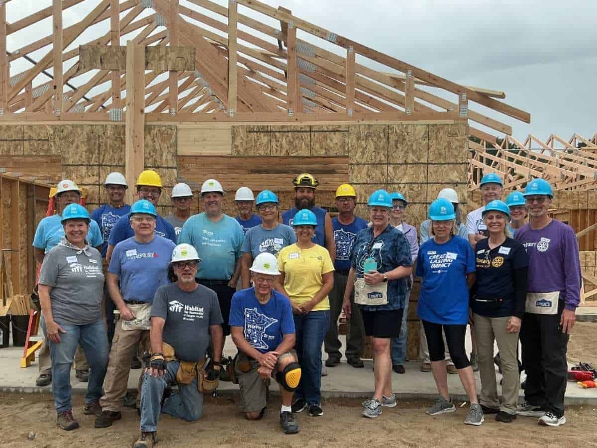Club members in front of a Habitat for Humanity house they helped to build